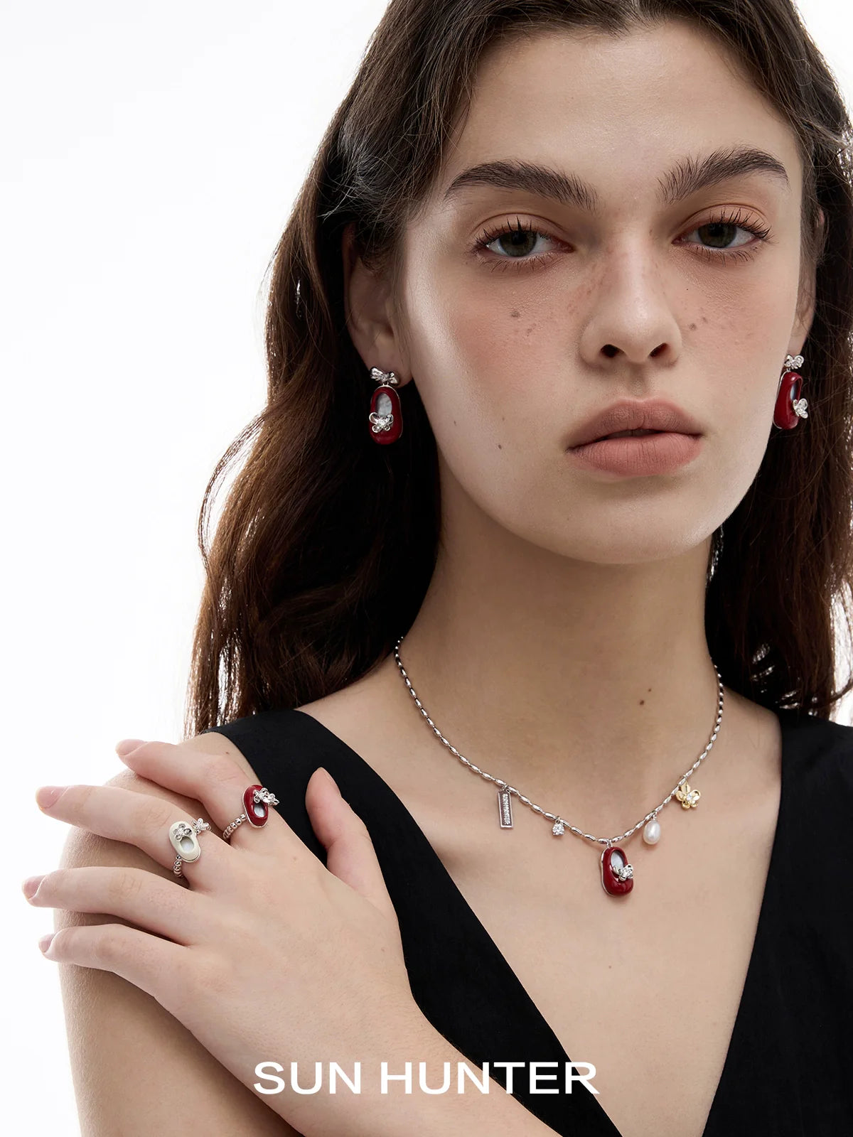 Model wearing elegant jewelry featuring butterfly shoe rings and matching earrings by SUN HUNTER
