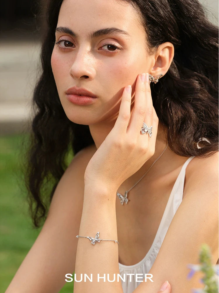 Elegant butterfly silver bracelet by SUN HUNTER worn by a model, showcasing delicate design and shine