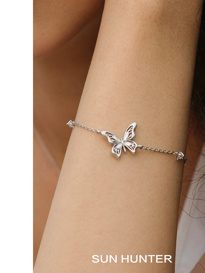 Elegant SUN HUNTER butterfly silver bracelet with intricate butterfly design on a delicate chain