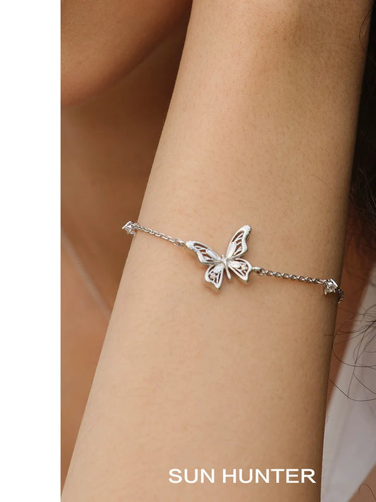 Elegant SUN HUNTER butterfly silver bracelet with intricate butterfly design on a delicate chain