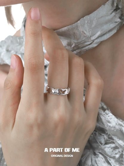 A PART OF ME butterfly silver ring shown worn on a hand with a textured design