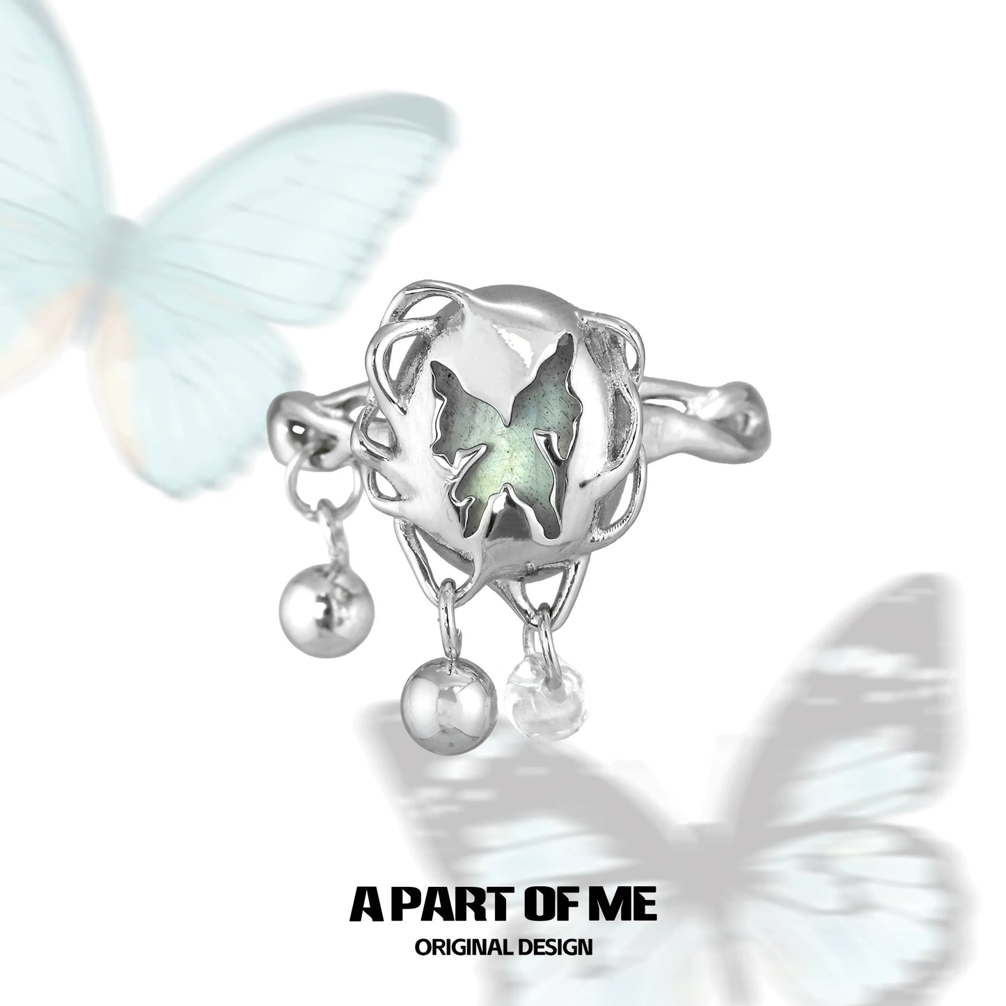 Butterfly silver ring featuring intricate design with charms and a unique butterfly motif