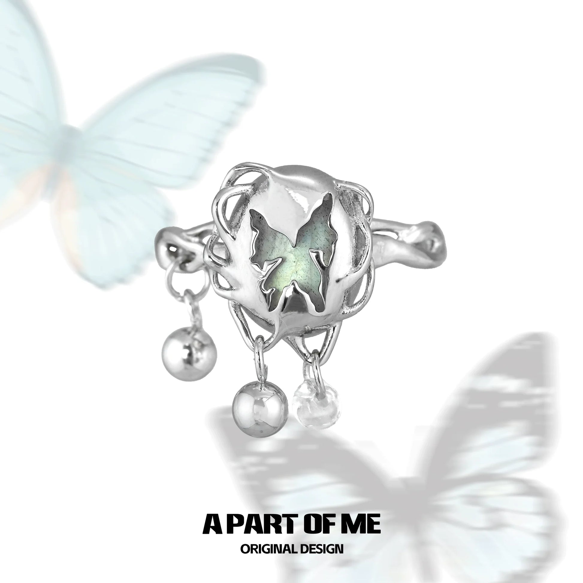 Butterfly silver ring featuring intricate design with charms and a unique butterfly motif