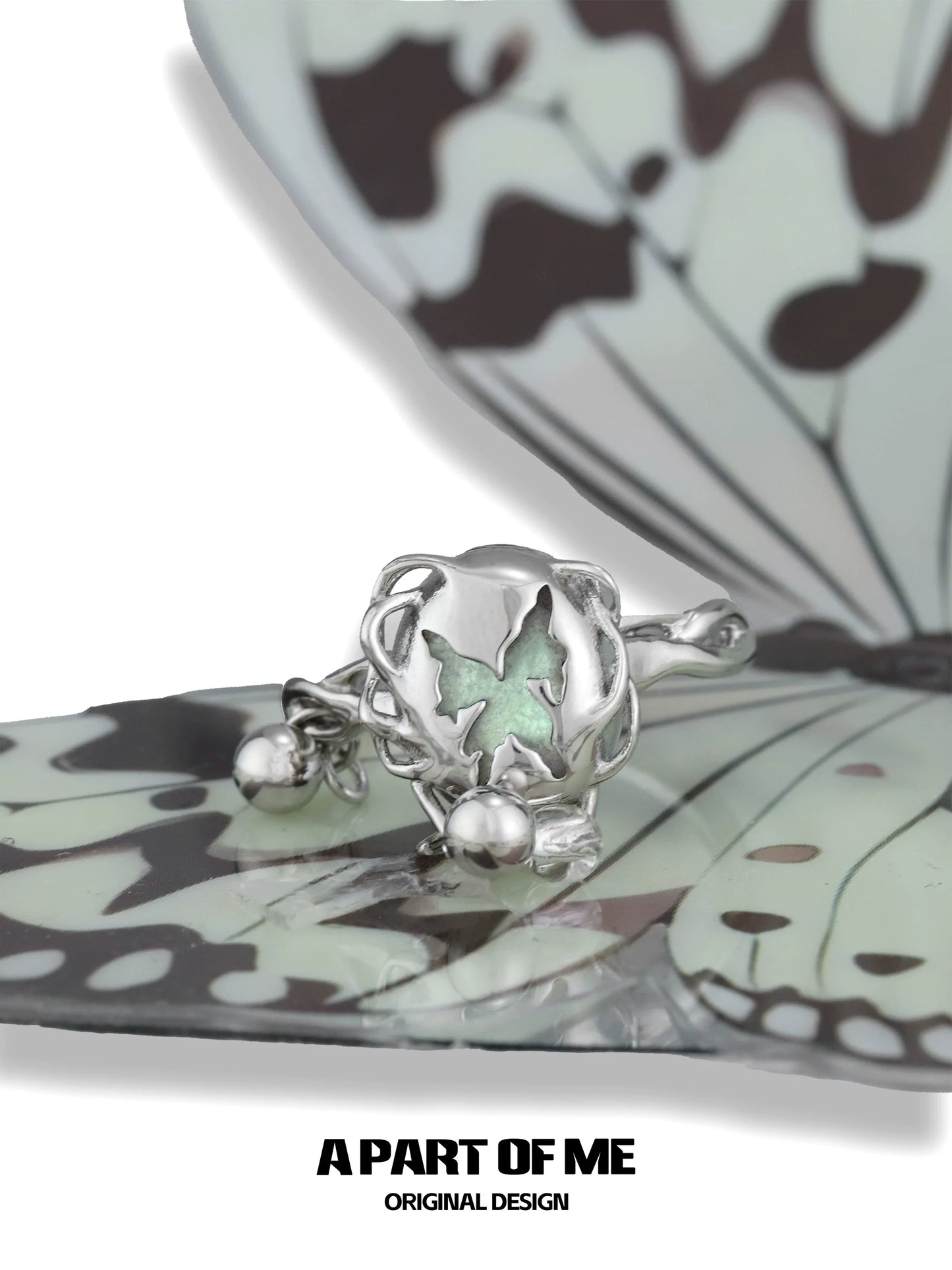 A PART OF ME butterfly silver ring featuring a delicate butterfly design with a green accent
