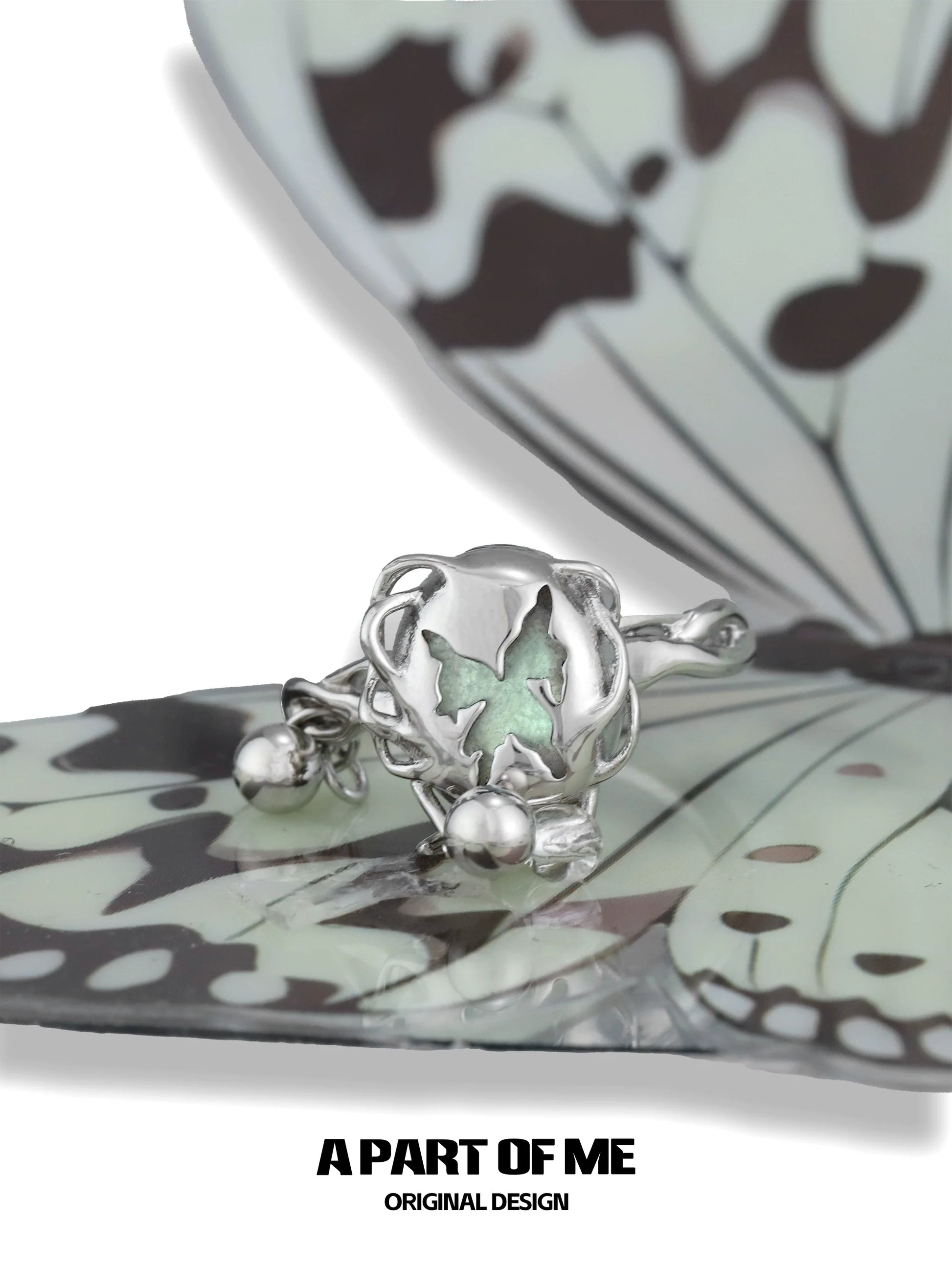A PART OF ME butterfly silver ring featuring a delicate butterfly design with a green accent