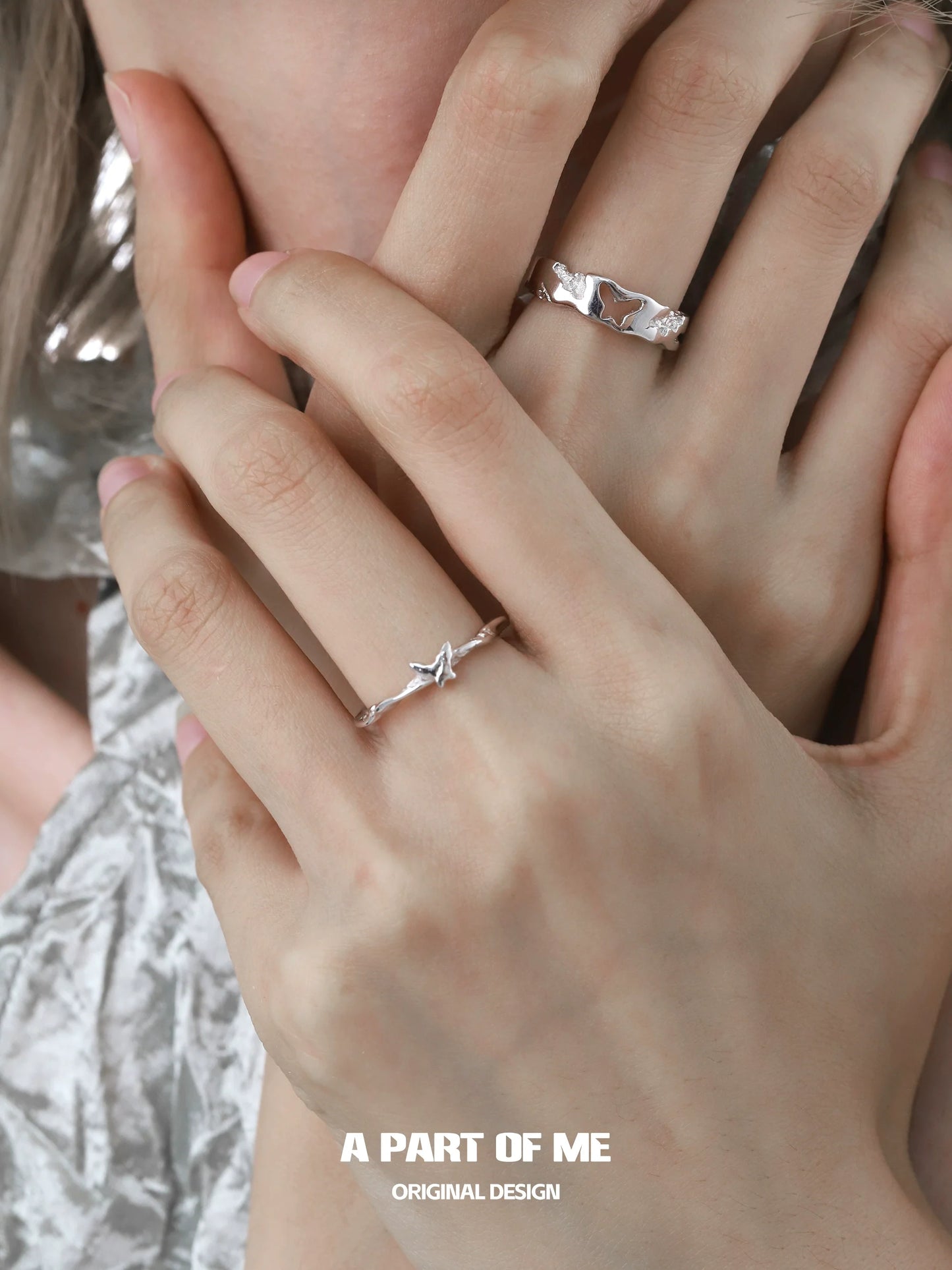 Elegant butterfly silver ring showcased on delicate hands with another silver ring