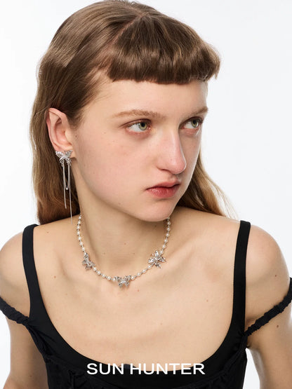 SUN HUNTER butterfly tassel ear cuffs with elegant chain detailing showcased on model