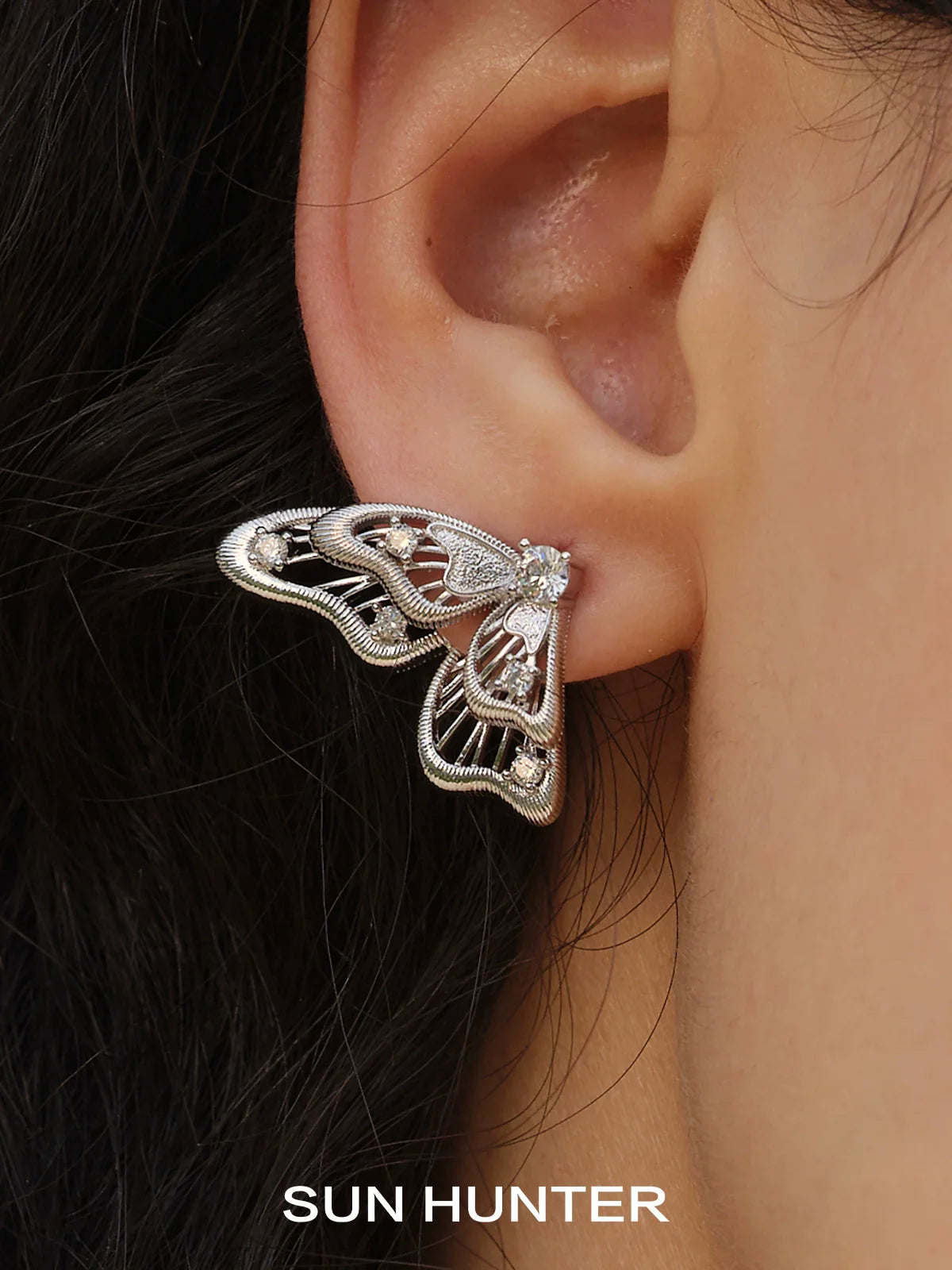 Elegant SUN HUNTER butterfly wing earrings featuring intricate design and sparkling stone detail