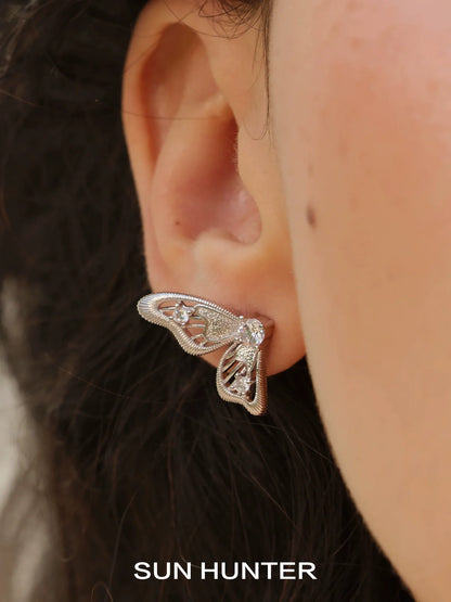 Elegant SUN HUNTER butterfly wing earrings with sparkling accents for a stylish look