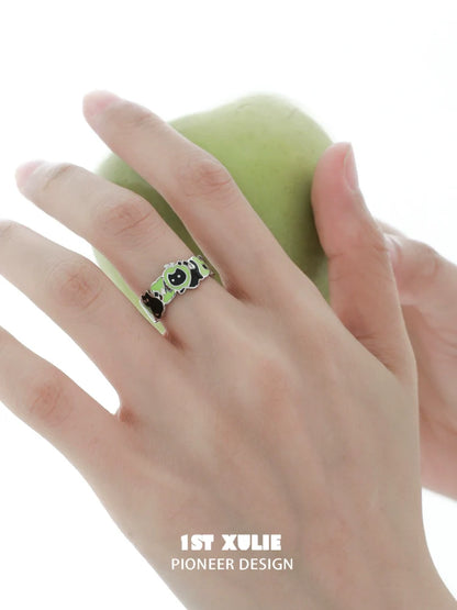 Stylish cat and dog silver ring by 1STXULIE on a hand holding a green apple