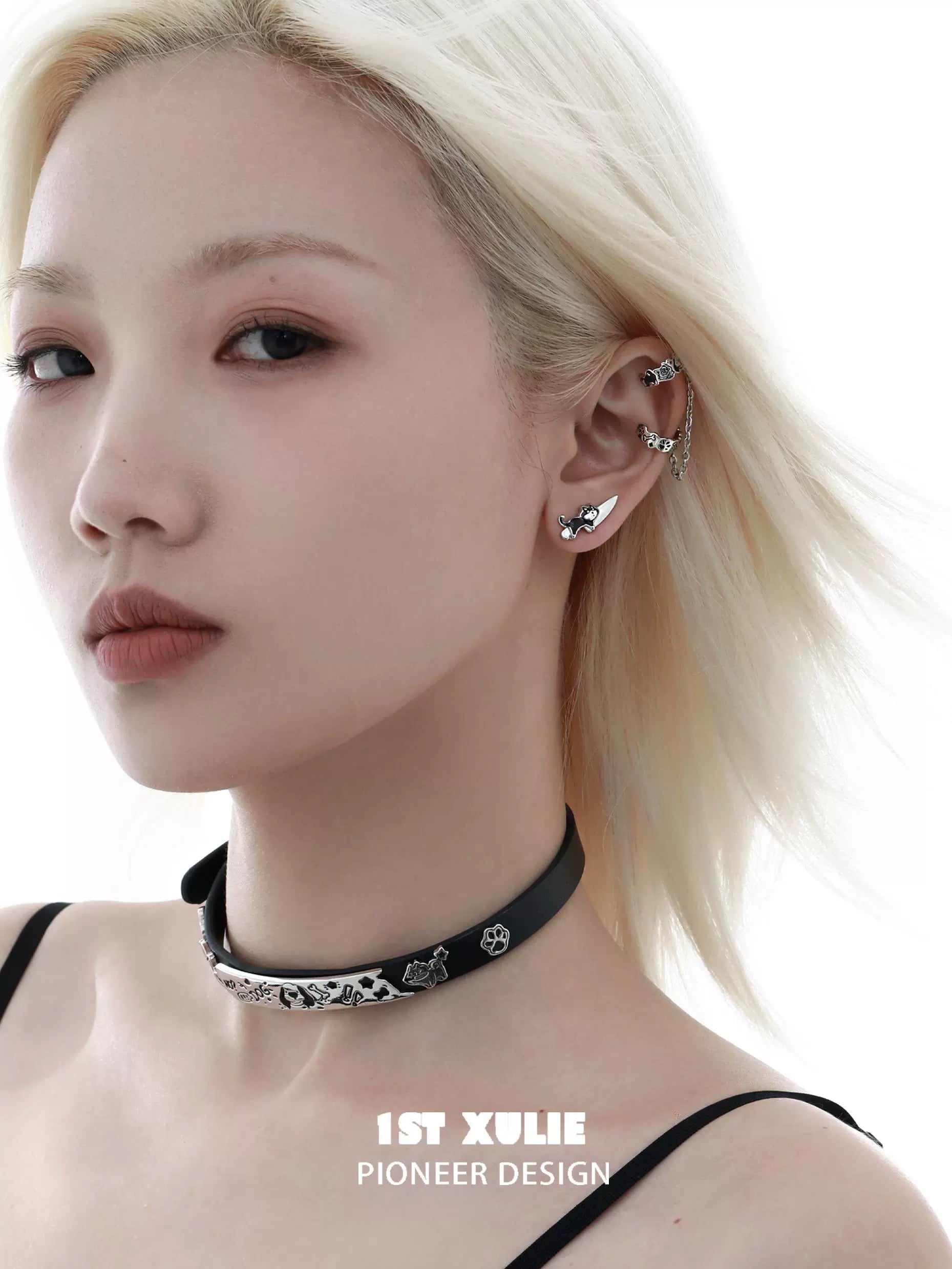 1STXULIE cat and dog stud earrings in a model's ear, showcasing a stylish and playful design