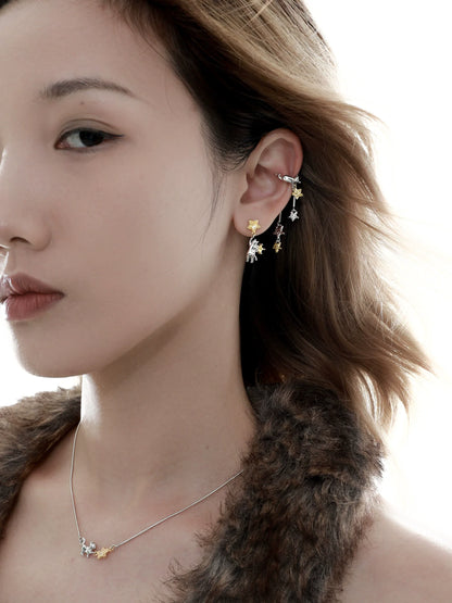 Stylish cat ear cuffs featuring playful designs, worn elegantly on a model's ear