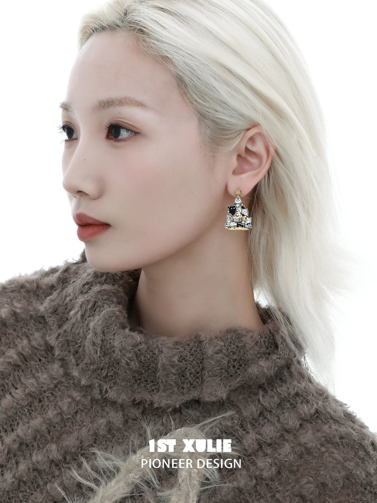 Stylish cat family silver stud earrings showcased on a model with a soft sweater