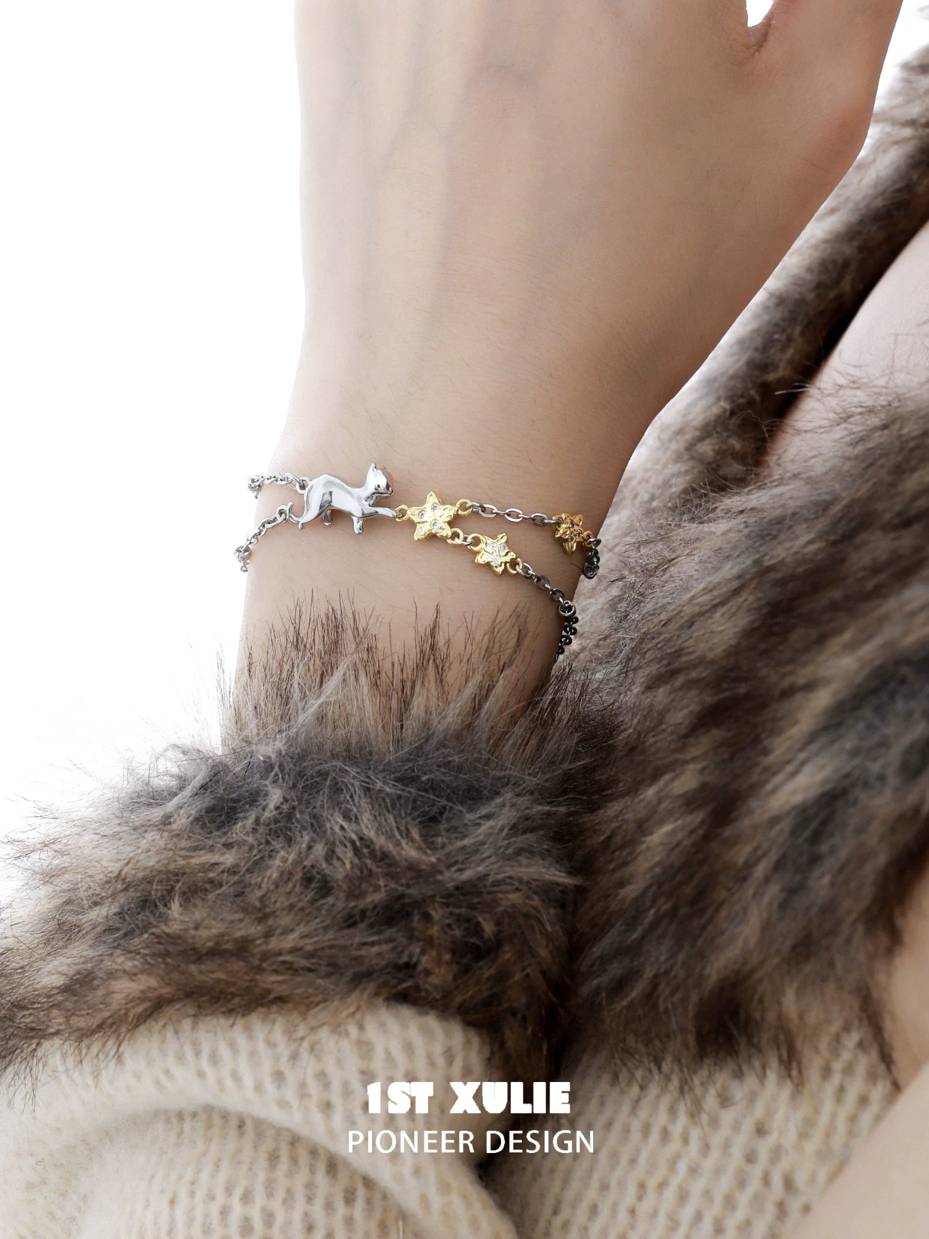 Silver and gold cat star bracelet featuring a playful cat and star charms for stylish pet lovers