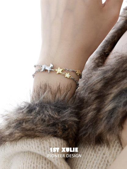 Silver and gold cat star bracelet featuring a playful cat and star charms for stylish pet lovers