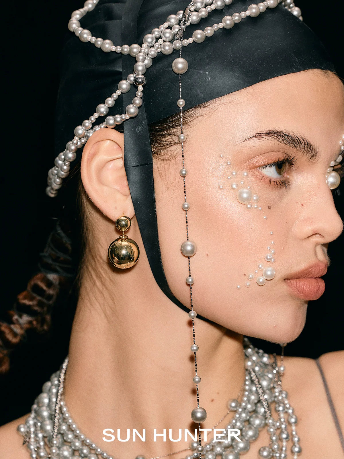 Elegant SUN HUNTER celestial planet gravity earrings showcased on a model with a stylish headpiece