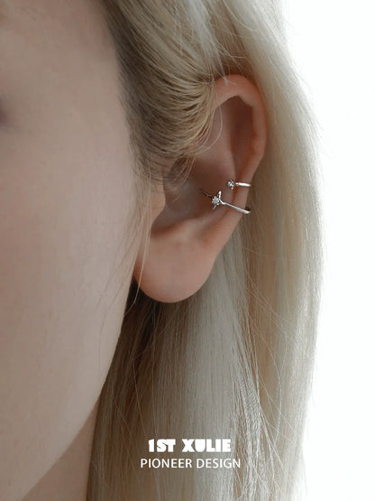 Close-up of a model wearing celestial zircon ear cuffs designed by 1STXULIE for a stylish look