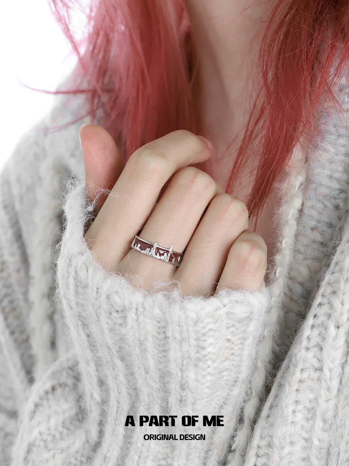 Stylish city skyline silver ring worn on a hand with soft knit sweater