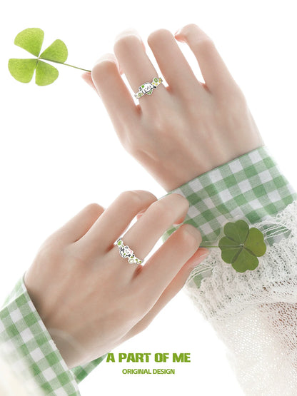 A PART OF ME clover cat puppy couple rings displayed on two hands with a green background