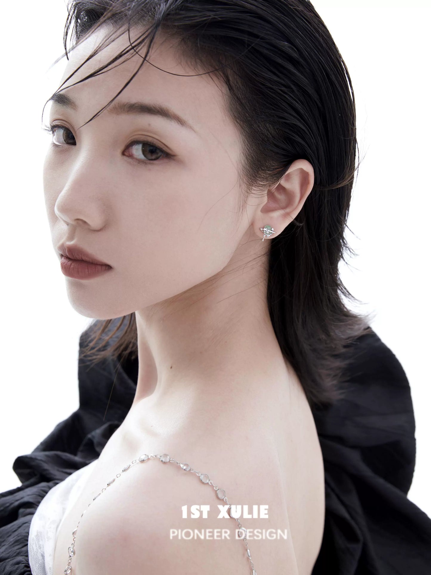 Elegant model wearing 1ST XULIE cosmic meteorite earrings showcasing unique design and style