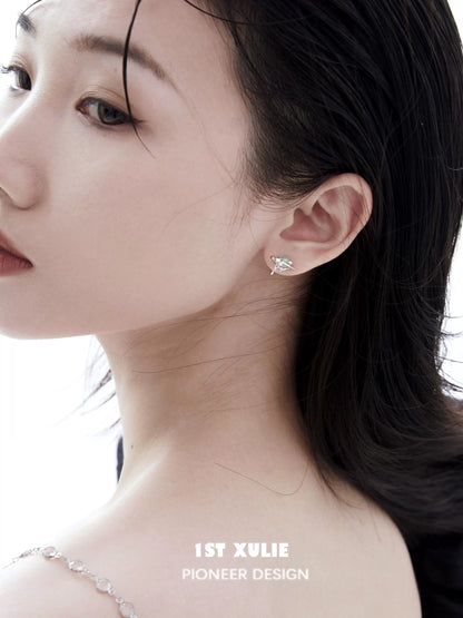 Elegant model wearing 1ST XULIE cosmic meteorite earrings with a shimmering design for a stylish look