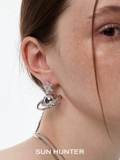 SUN HUNTER cosmic planet star earrings featuring a shiny planet and star design for galaxy lovers
