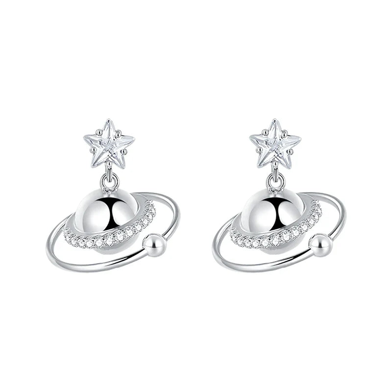 SUN HUNTER cosmic planet star earrings in silver with sparkling details and star accents