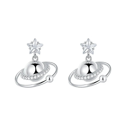 SUN HUNTER cosmic planet star earrings in silver with sparkling details and star accents