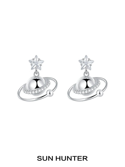 SUN HUNTER cosmic planet star earrings featuring a star and planet design with sparkling accents