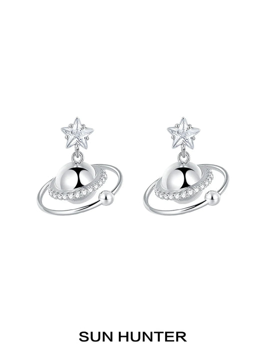 SUN HUNTER cosmic planet star earrings featuring a star and planet design with sparkling accents