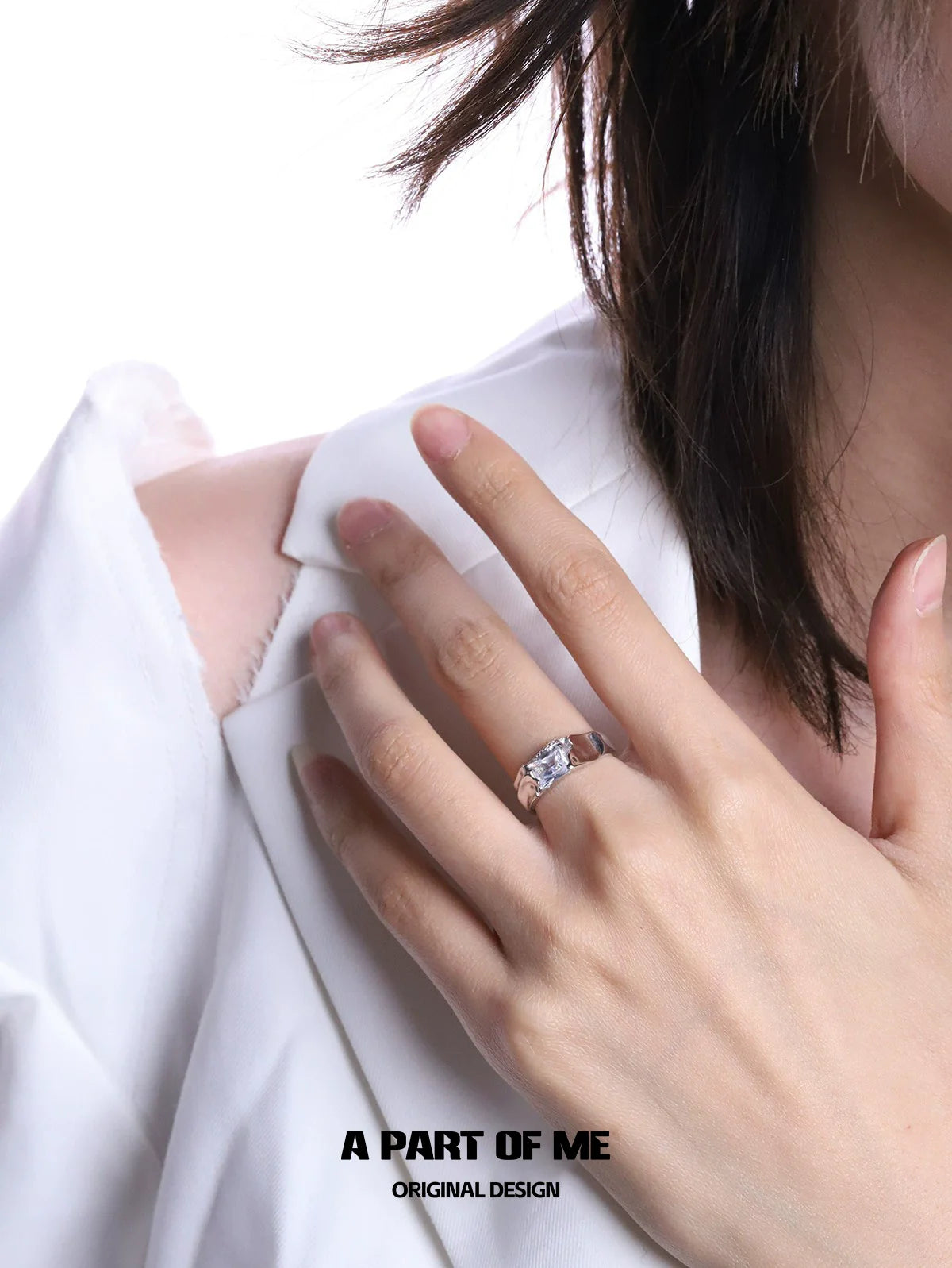 Elegant cracked texture silver ring showcased on model's hand with stylish clothing