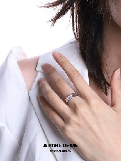 Elegant cracked texture silver ring showcased on model's hand with stylish clothing