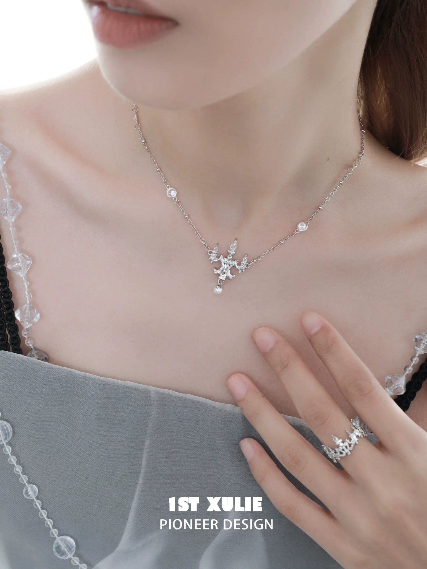 Elegant crystal lamp silver necklace from 1ST XULIE showcasing a stunning design with sparkling crystals.
