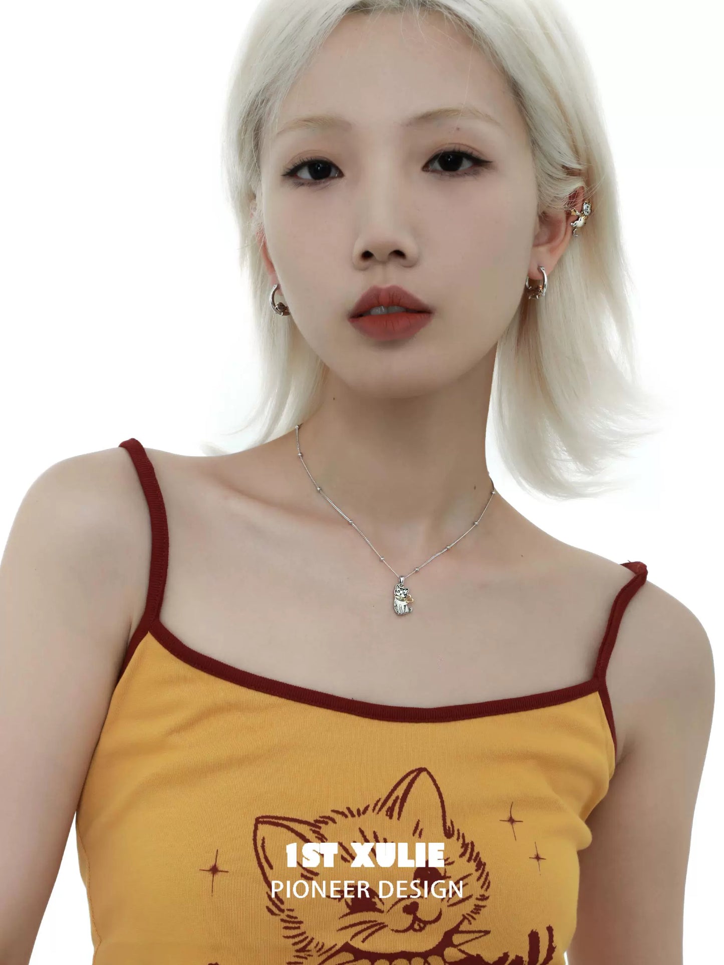 Cute cat ear clips worn by a model with a stylish outfit showcasing a trendy look