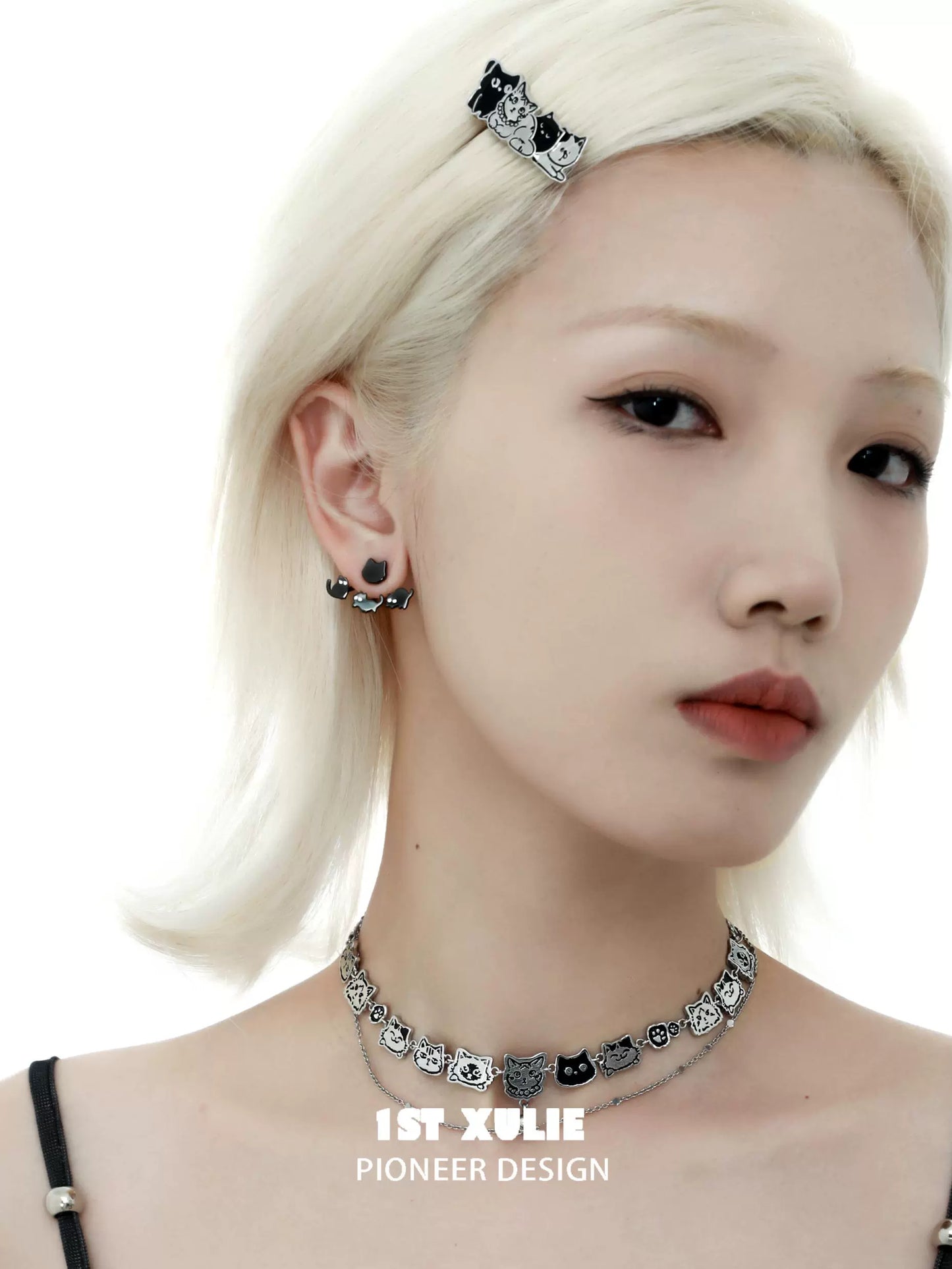 Model wearing cute cat earrings removable with matching choker and hair clip accessories