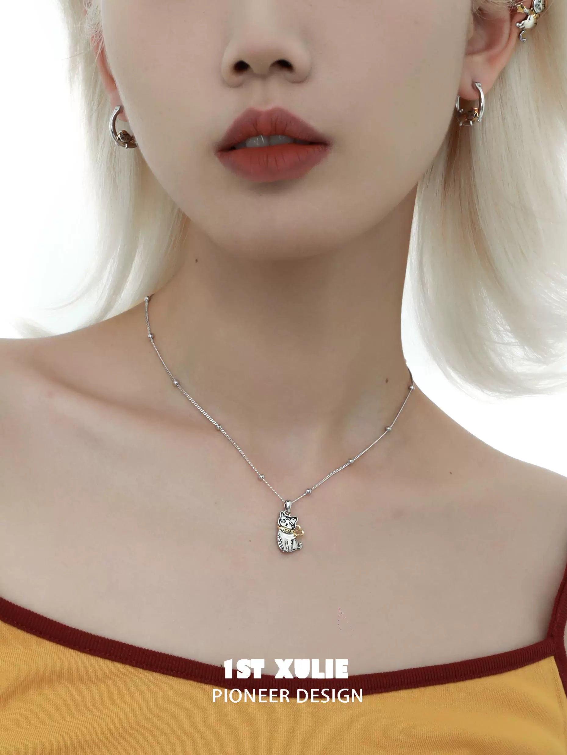 Cute cat necklace from 1STXULIE featuring a silver pendant on a delicate chain