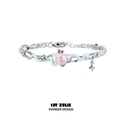 Cute snake apple bracelet featuring a pink heart charm and silver accents for a playful accessory