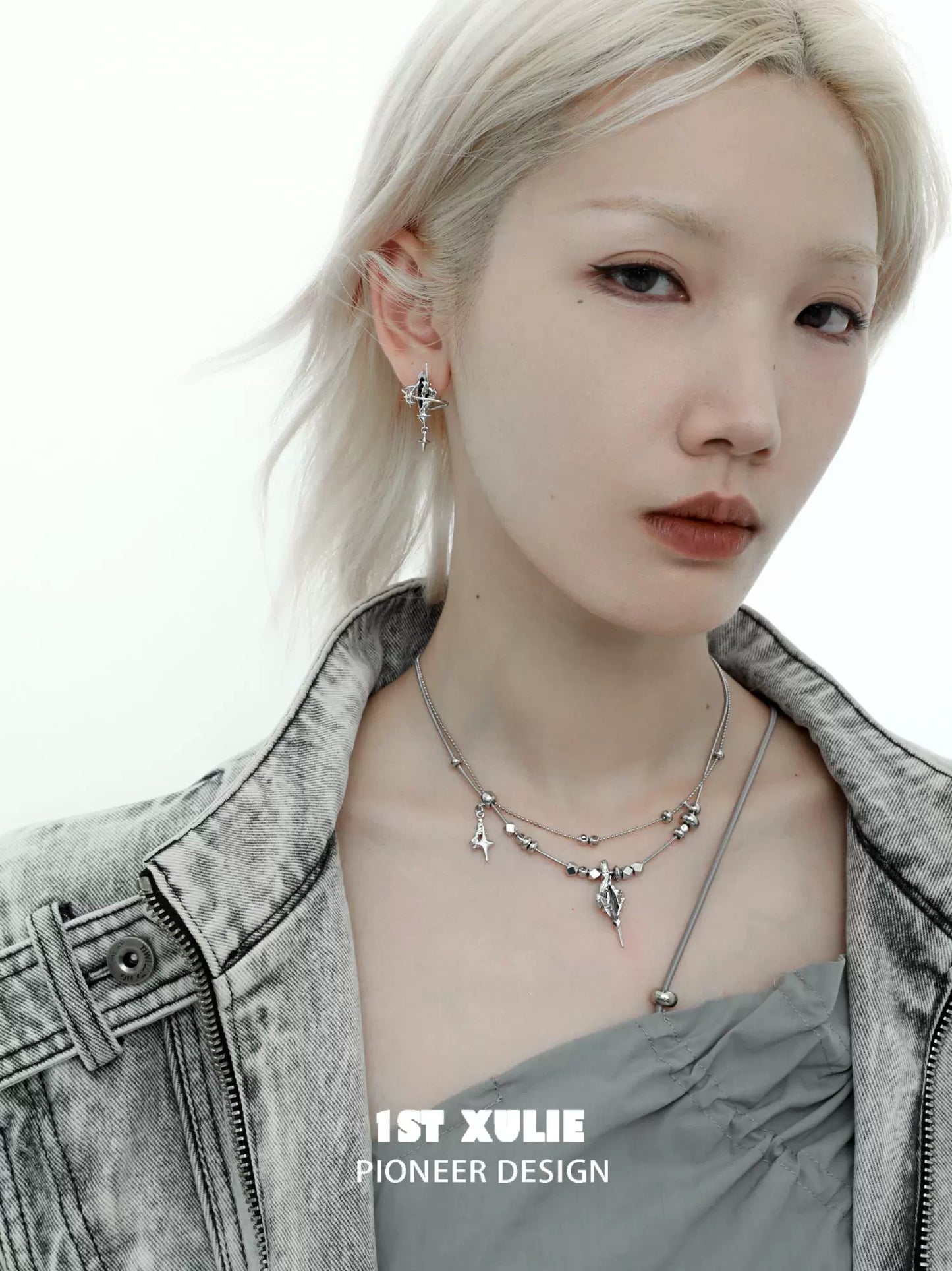 Stylish model wearing a dark dreamcore necklace layered with unique charms and silver chains