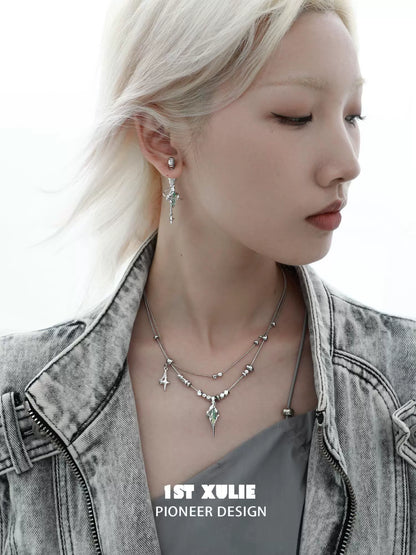 Model wearing a dark dreamcore necklace featuring unique silver charms and a layered design