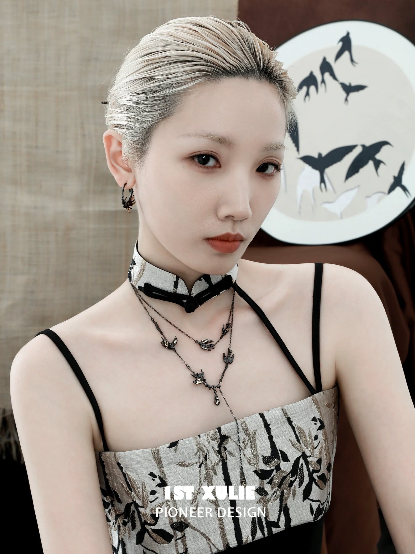 Elegant model wearing a dark swallow necklace that complements a stylish outfit, showcasing a modern design.