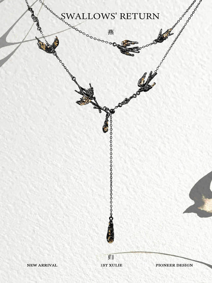 Dark swallow necklace featuring elegant design with multiple swallows and a hanging drop detail