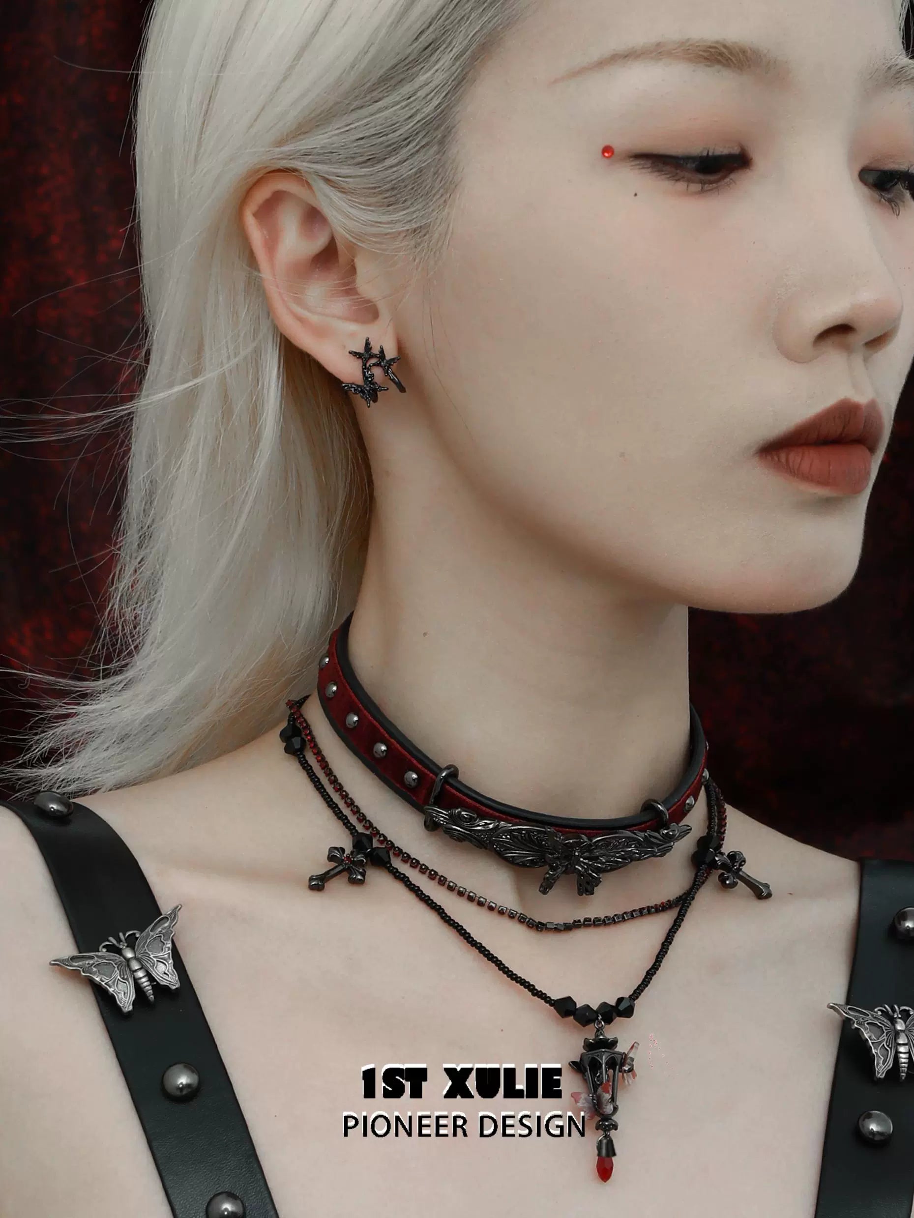 Model wearing dark thorn butterfly earrings with a gothic choker and layered necklaces for a unique look