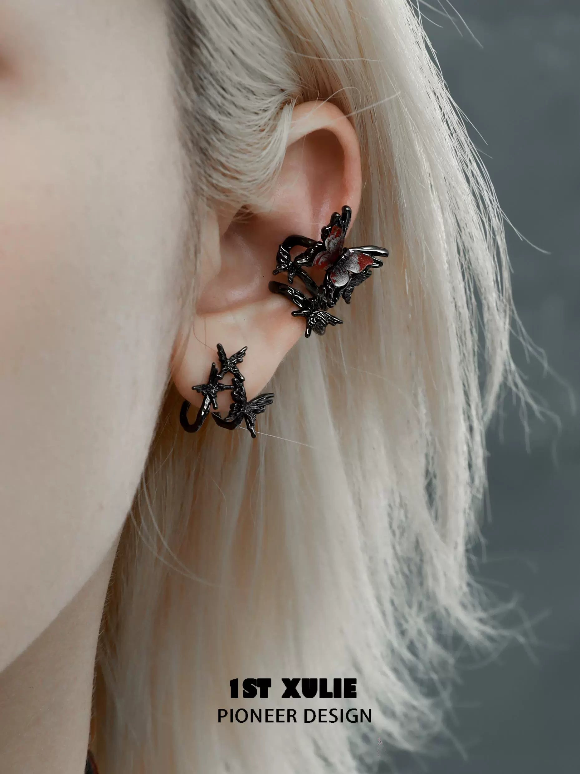Dark thorn butterfly earrings in black metal design worn on an ear for a unique fashion statement