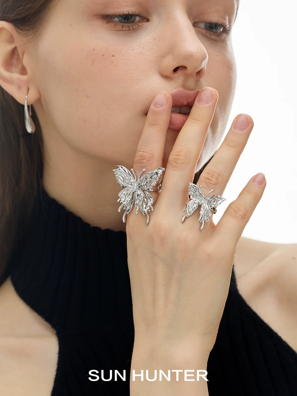 Elegant silver double-layer butterfly ring showcased on two fingers for a stunning jewelry look