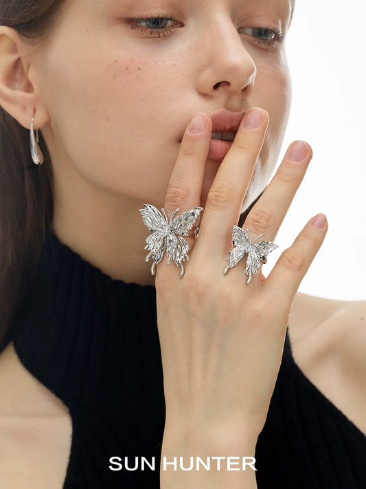 Elegant silver double-layer butterfly ring showcased on two fingers for a stunning jewelry look