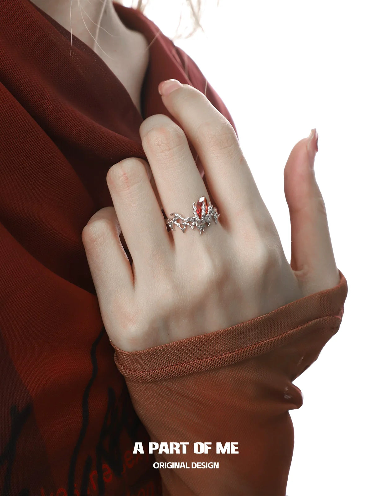 A PART OF ME dragon claw ruby ring featuring intricate design and sparkling details on a model's hand