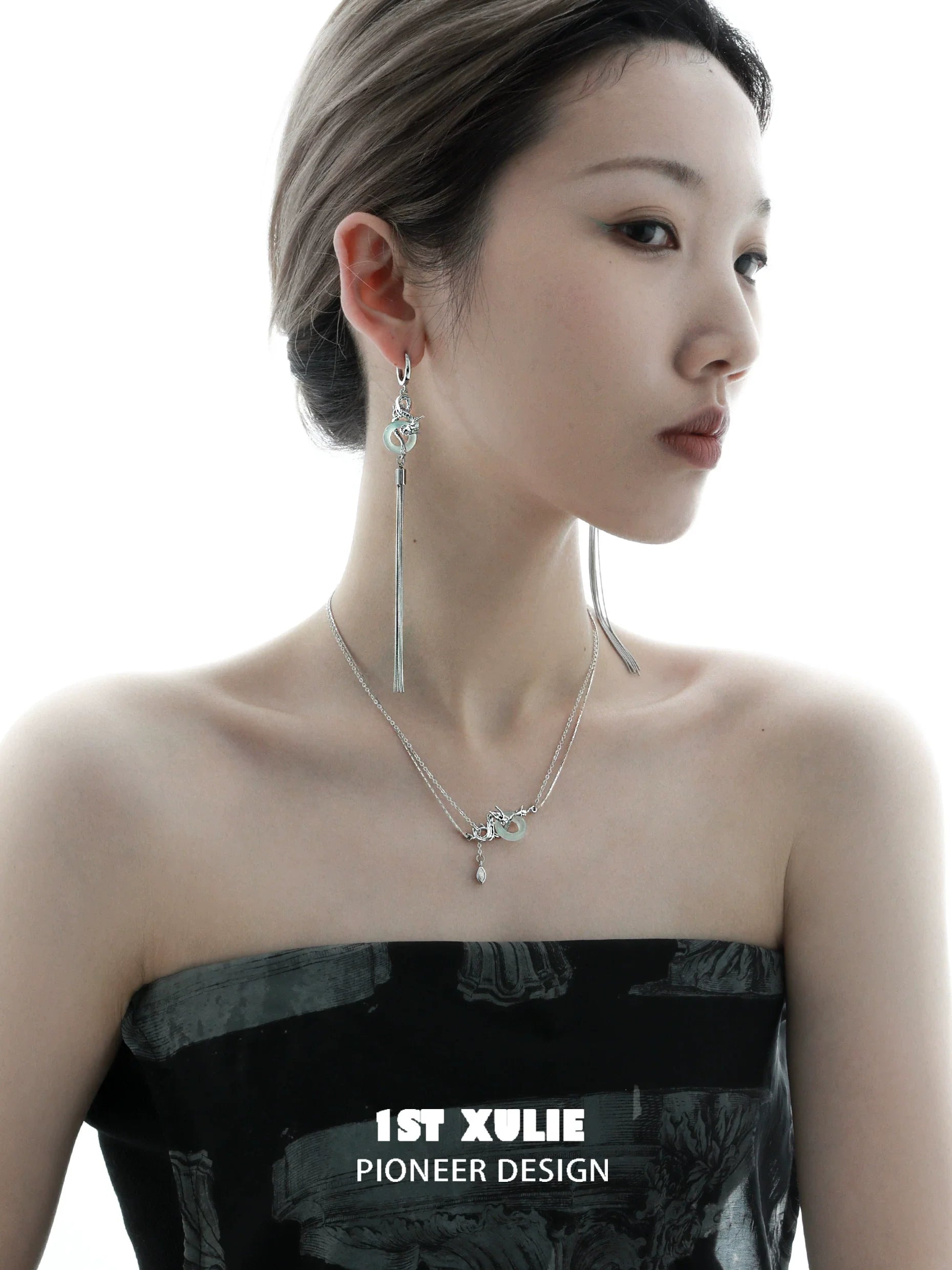 Elegant model showcasing a dragon silver necklace paired with stylish earrings