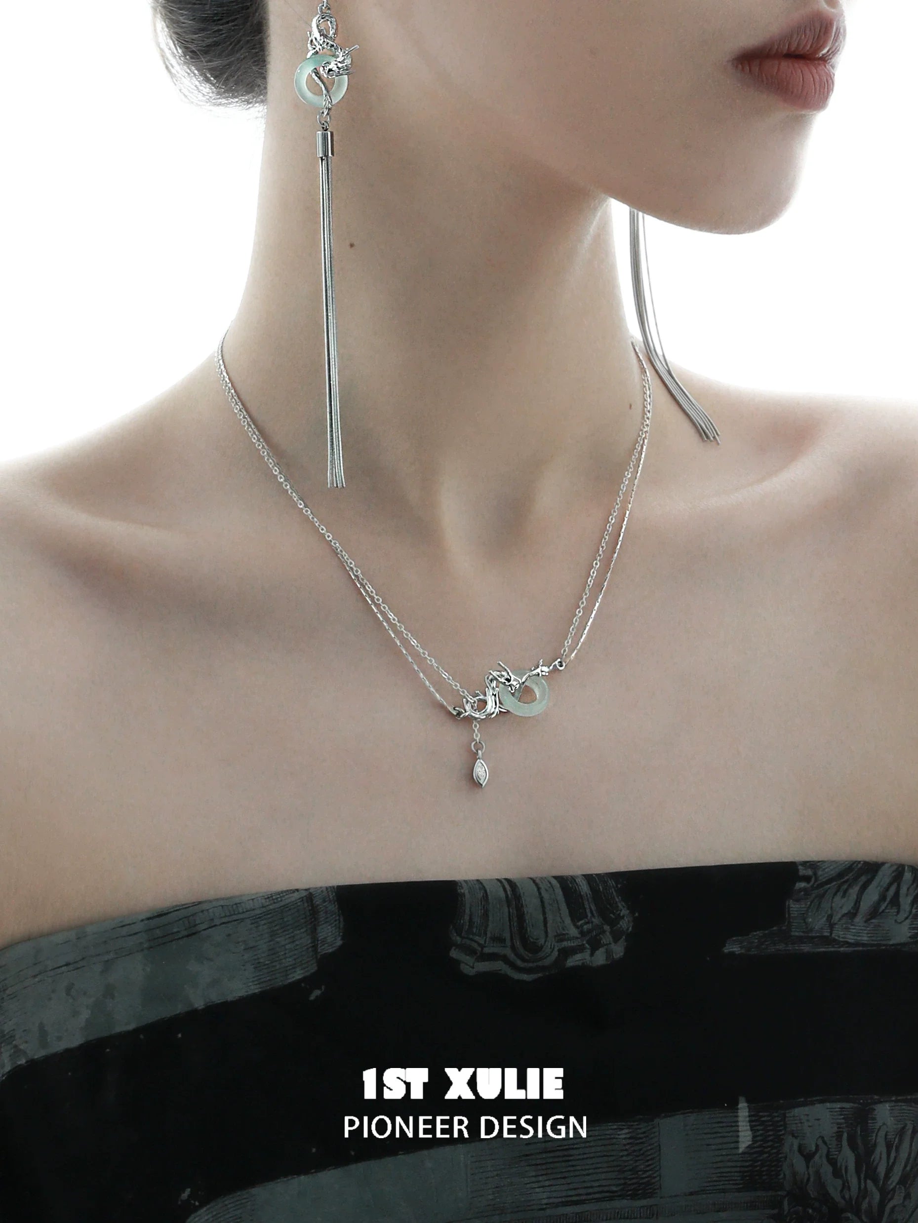Delicate dragon silver necklace layered with charms, perfect for elegant outfits and statement looks