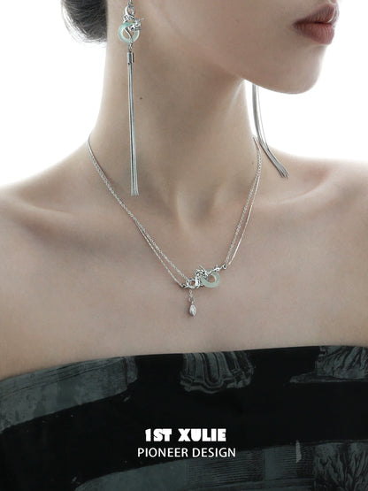 Delicate dragon silver necklace layered with charms, perfect for elegant outfits and statement looks