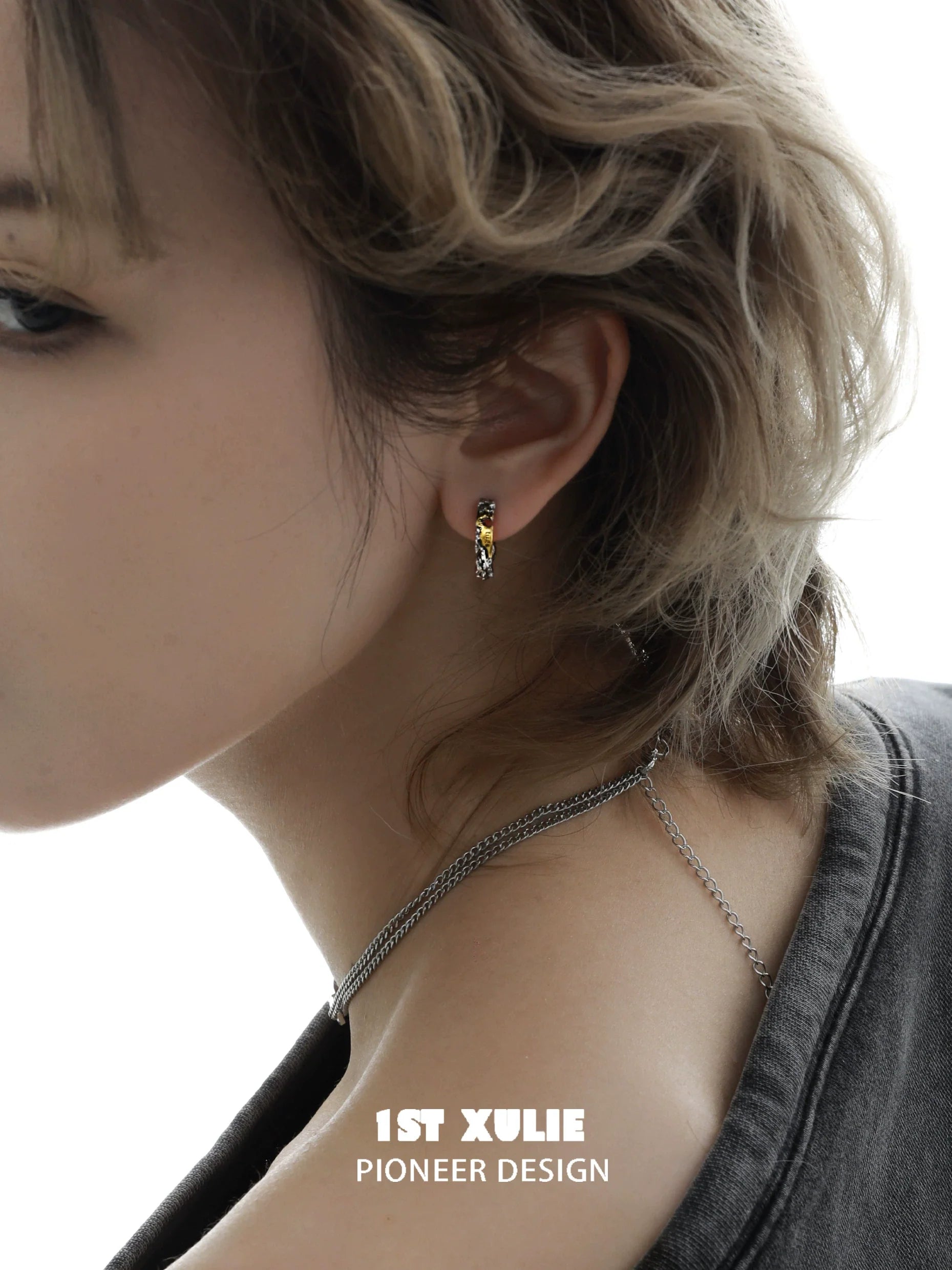 Edgy love letter earrings featured on a model for a fashionable look